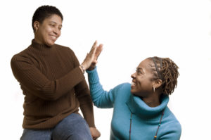Image of two women giving a high five